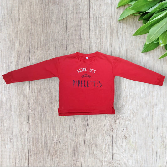 Pull rouge fille 6 ans Districenter avec inscription “Reine des pipelettes” et couronne